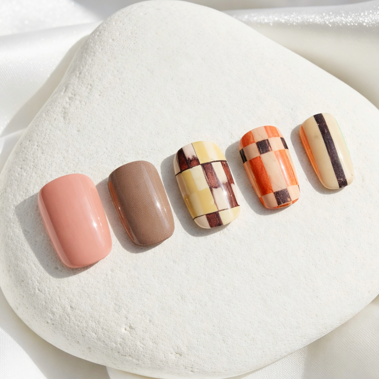Soft muted pink and brown checkered design press-on nails.