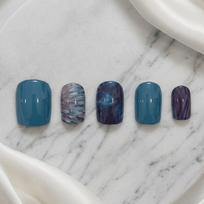 Deep blue and teal abstract marble press-on nails, sophisticated dark art design