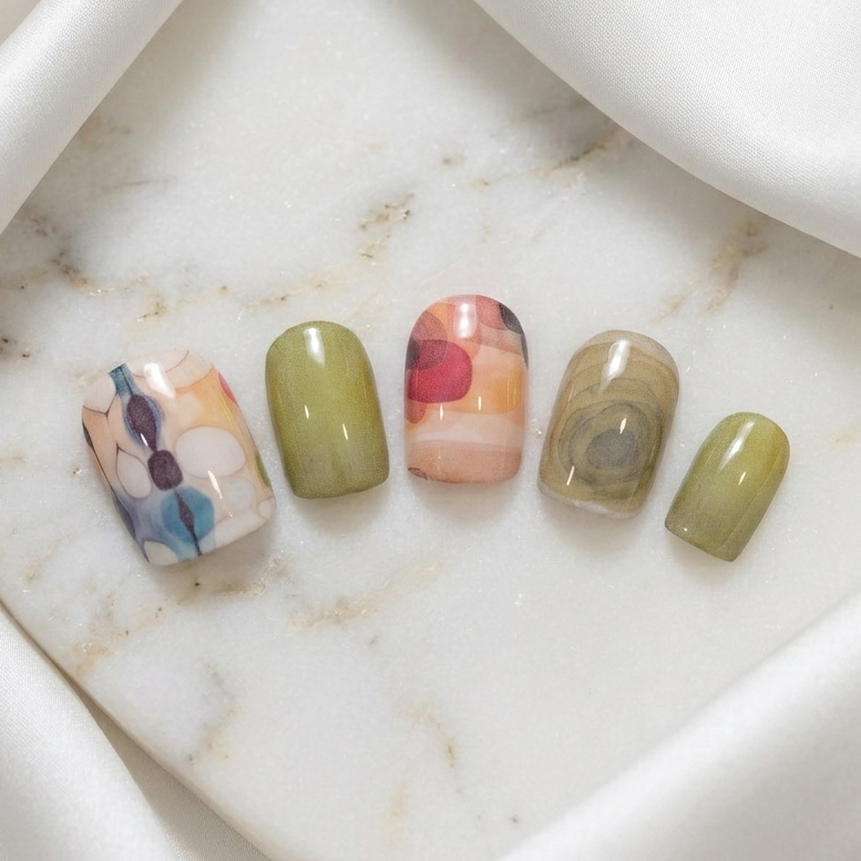 Abstract painterly botanical press-on nails, creative artistic nail design with circular motifs